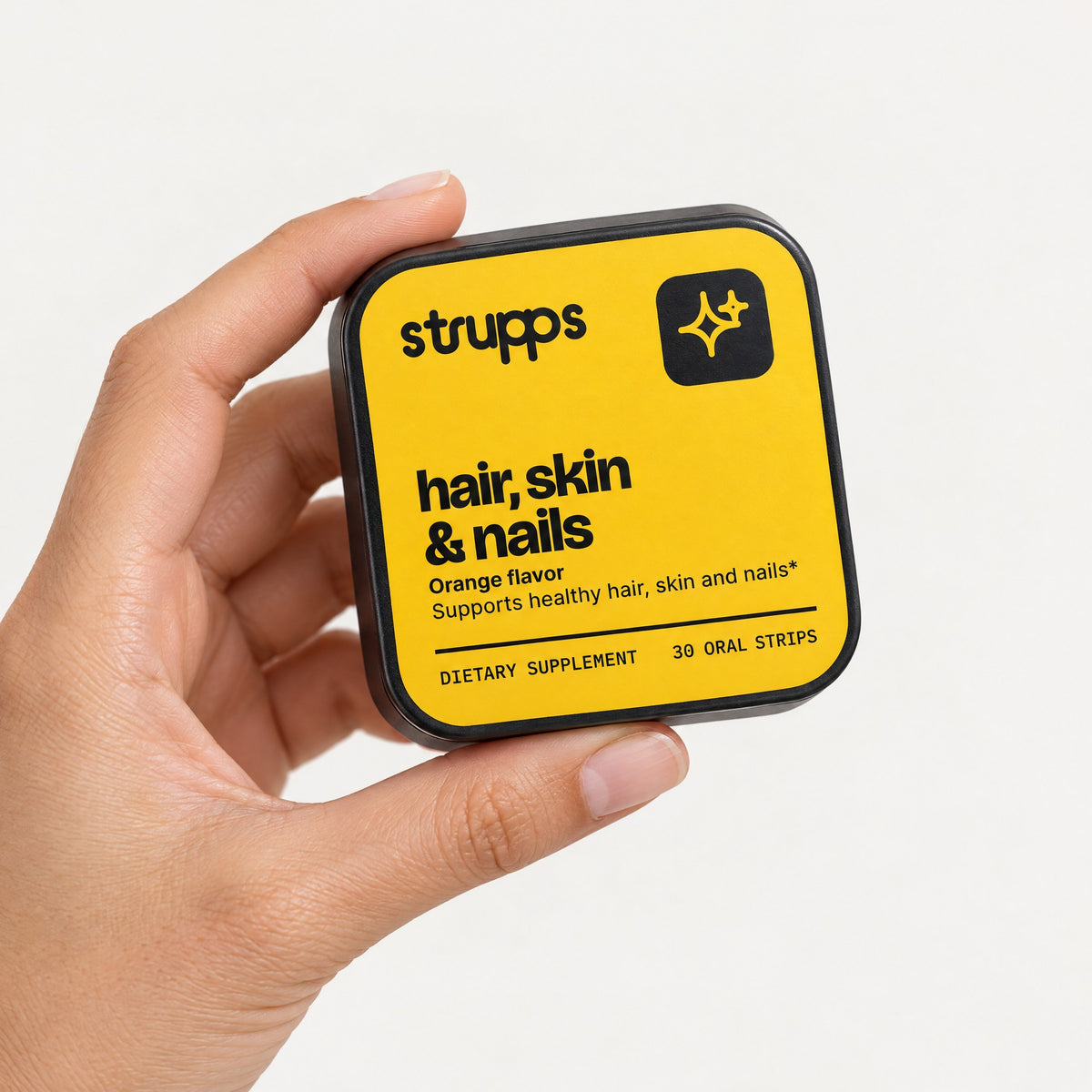The Hair, Skin and Nails Strip tin held in hand